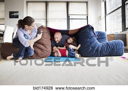 Family playing in blanket fort View Large Photo Image Stock Photo - Family playing in blanket fort. Fotosearch