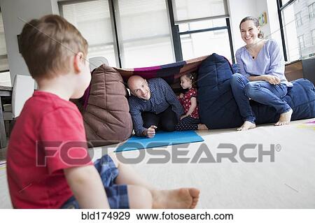 Stock Photo - Family playing in blanket fort. Fotosearch