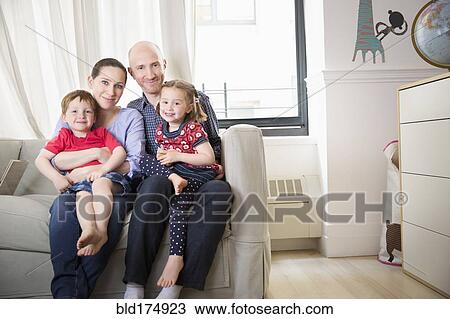 Family smiling on sofa View Large Photo Image Stock Image - Family smiling on sofa. Fotosearch