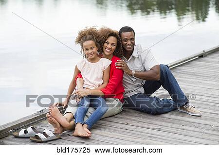 Family smiling on wooden dock View Large Photo Image Stock Photography - Family smiling on wooden dock. Fotosearch