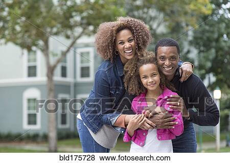 Family smiling outdoors View Large Photo Image Stock Photo - Family smiling outdoors. Fotosearch