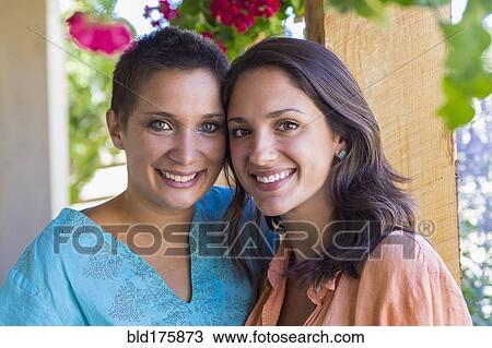 Stock Image - Friends smiling outdoors. Fotosearch