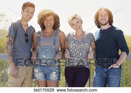 Stock Photo - Friends smiling outdoors. Fotosearch