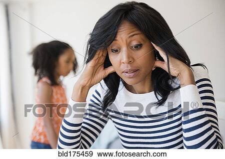 Frustrated mother rubbing her temples View Large Photo Image Stock Photo - Frustrated mother rubbing her temples. Fotosearch