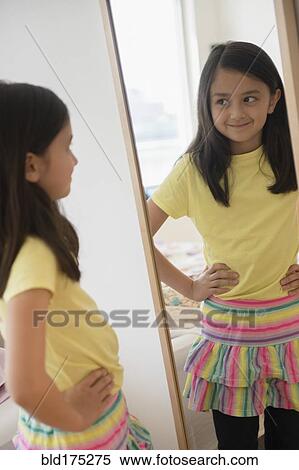 Girl admiring herself in mirror View Large Photo Image Stock Photography - Girl admiring herself in mirror. Fotosearch