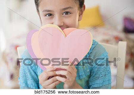 Stock Photograph - Girl holding paper hearts. Fotosearch