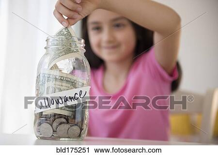 Girl saving allowance in money jar View Large Photo Image Stock Image - Girl saving allowance in money jar. Fotosearch