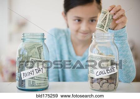 Girl saving money in college fund View Large Photo Image Stock Photo - Girl saving money in college fund. Fotosearch