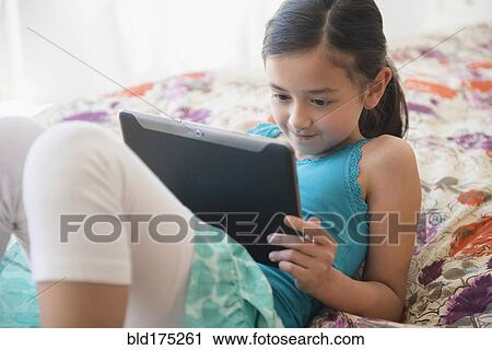Stock Image - Girl using digital tablet. Fotosearch