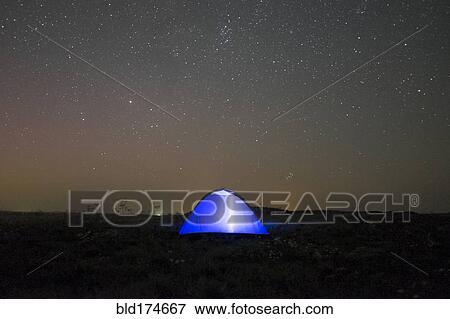 Stock Photo - Glowing tent under starry night sky. Fotosearch