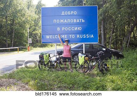 Stock Photography - Hispanic biker cheering at Russian border. Fotosearch