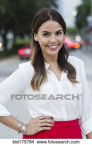 Picture - Hispanic businesswoman smiling outdoors. Fotosearch