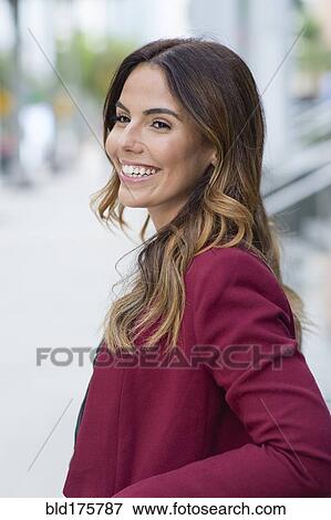 Stock Photo - Hispanic businesswoman smiling outdoors. Fotosearch