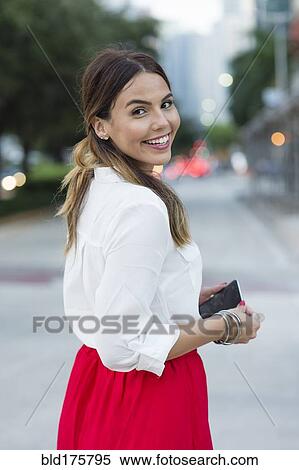 Stock Photography - Hispanic businesswoman smiling outdoors. Fotosearch