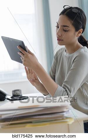 Hispanic businesswoman using digital tablet View Large Photo Image Stock Photography - Hispanic businesswoman using digital tablet. Fotosearch