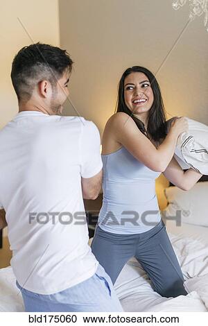Hispanic couple having pillow fight View Large Photo Image Stock Image - Hispanic couple having pillow fight. Fotosearch