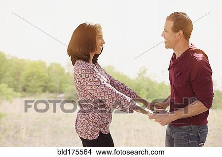 Hispanic couple holding hands outdoors View Large Photo Image Picture - Hispanic couple holding hands outdoors. Fotosearch