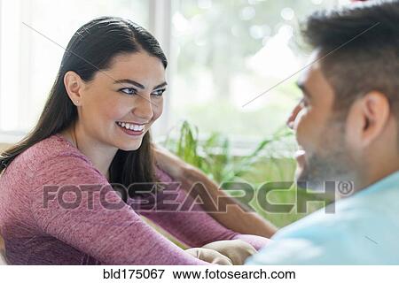 Stock Photo - Hispanic couple talking indoors. Fotosearch