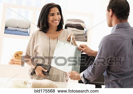Hispanic customer shopping in store View Large Photo Image Stock Photo - Hispanic customer shopping in store. Fotosearch