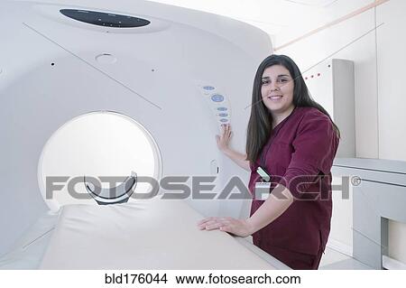 Picture - Hispanic doctor operating MRI machine. Fotosearch