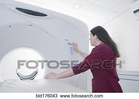 Hispanic doctor operating MRI machine View Large Photo Image Stock Image - Hispanic doctor operating MRI machine. Fotosearch