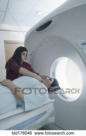 Hispanic nurse examining patient in MRI machine View Large Photo Image Stock Photograph - Hispanic nurse examining patient in MRI machine. Fotosearch