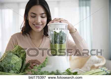 Hispanic woman blending healthy smoothie View Large Photo Image Stock Photo - Hispanic woman blending healthy smoothie. Fotosearch