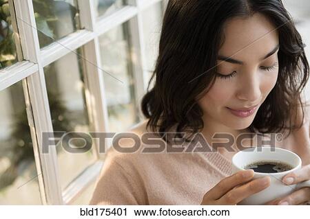 Hispanic woman drinking cup of coffee View Large Photo Image Stock Image - Hispanic woman drinking cup of coffee. Fotosearch