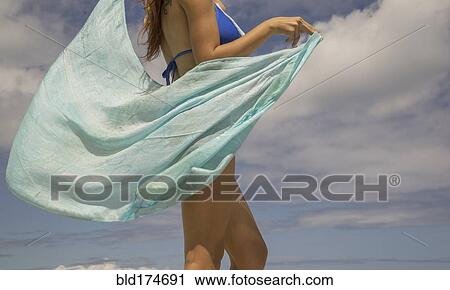 Hispanic woman holding sarong blowing in wind View Large Photo Image Stock Image - Hispanic woman holding sarong blowing in wind. Fotosearch
