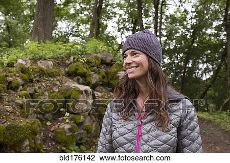 Stock Image - Hispanic woman in forest. Fotosearch