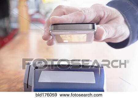 Hispanic woman scanning credit card from cell phone View Large Photo Image Stock Photo - Hispanic woman scanning credit card from cell phone. Fotosearch