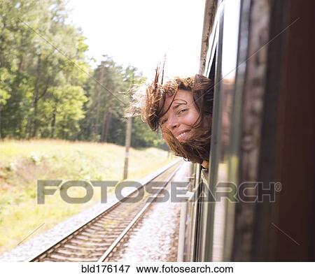 Stock Photo - Hispanic woman with head out train window. Fotosearch