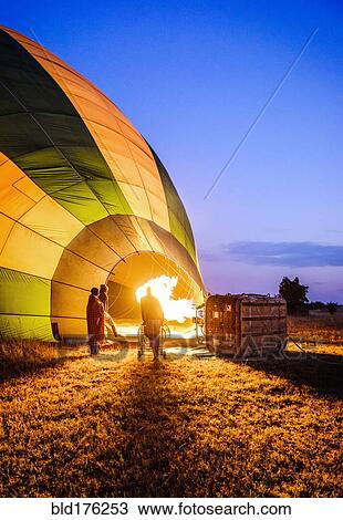 Hot air balloon inflating in rural field View Large Photo Image Stock Image - Hot air balloon inflating in rural field. Fotosearch