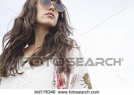Low angle view of Caucasian woman wearing sunglasses outdoors View Large Photo Image Stock Photograph - Low angle view of Caucasian woman wearing sunglasses outdoors. Fotosearch