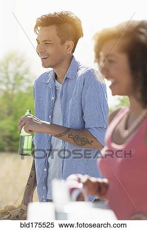 Stock Photography - Man drinking beer outdoors. Fotosearch