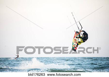 Man kiteboarding over ocean waves View Large Photo Image Stock Image - Man kiteboarding over ocean waves. Fotosearch