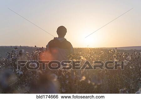 Stock Photograph - Mari man standing in field. Fotosearch