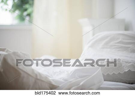 Stock Image - Messy sheets on bed. Fotosearch