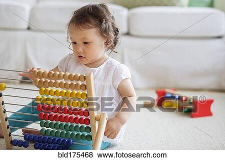 Mixed race baby girl playing with abacus View Large Photo Image Stock Photo - Mixed race baby girl playing with abacus. Fotosearch