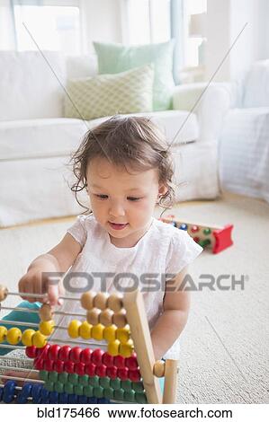 Mixed race baby girl playing with abacus View Large Photo Image Stock Photograph - Mixed race baby girl playing with abacus. Fotosearch