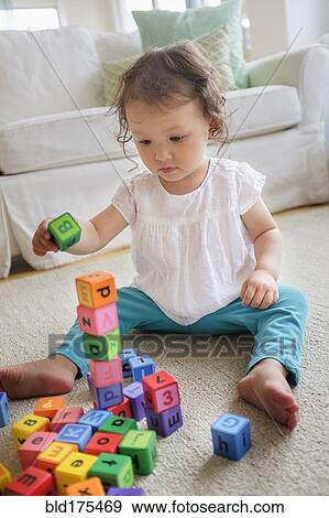 Mixed race baby girl playing with blocks View Large Photo Image Stock Photo - Mixed race baby girl playing with blocks. Fotosearch