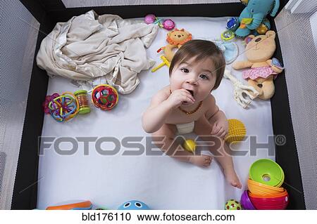 Mixed race baby girl sitting in playpen View Large Photo Image Stock Image - Mixed race baby girl sitting in playpen. Fotosearch