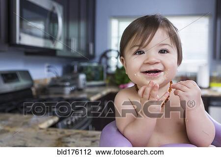 Mixed race baby girl smiling in kitchen View Large Photo Image Stock Image - Mixed race baby girl smiling in kitchen. Fotosearch