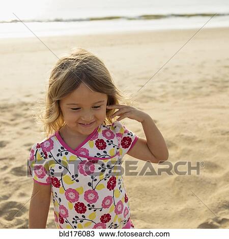 Mixed race girl smiling on beach View Large Photo Image Stock Image - Mixed race girl smiling on beach. Fotosearch