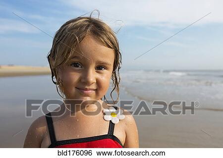 Mixed race girl smiling on beach View Large Photo Image Stock Photograph - Mixed race girl smiling on beach. Fotosearch
