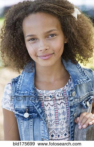 Mixed race girl smiling outdoors View Large Photo Image Stock Photo - Mixed race girl smiling outdoors. Fotosearch