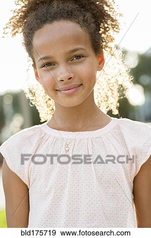 Mixed race girl smiling outdoors View Large Photo Image Stock Photo - Mixed race girl smiling outdoors. Fotosearch