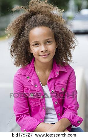 Stock Photo - Mixed race girl smiling outdoors. Fotosearch