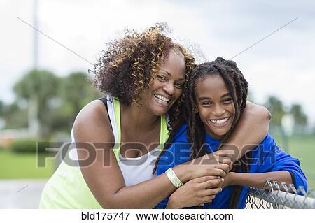 Mixed race mother and son hugging outdoors View Large Photo Image Stock Photo - Mixed race mother and son hugging outdoors. Fotosearch