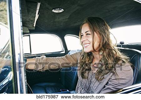 Stock Photo - Mixed race woman driving vintage car. Fotosearch